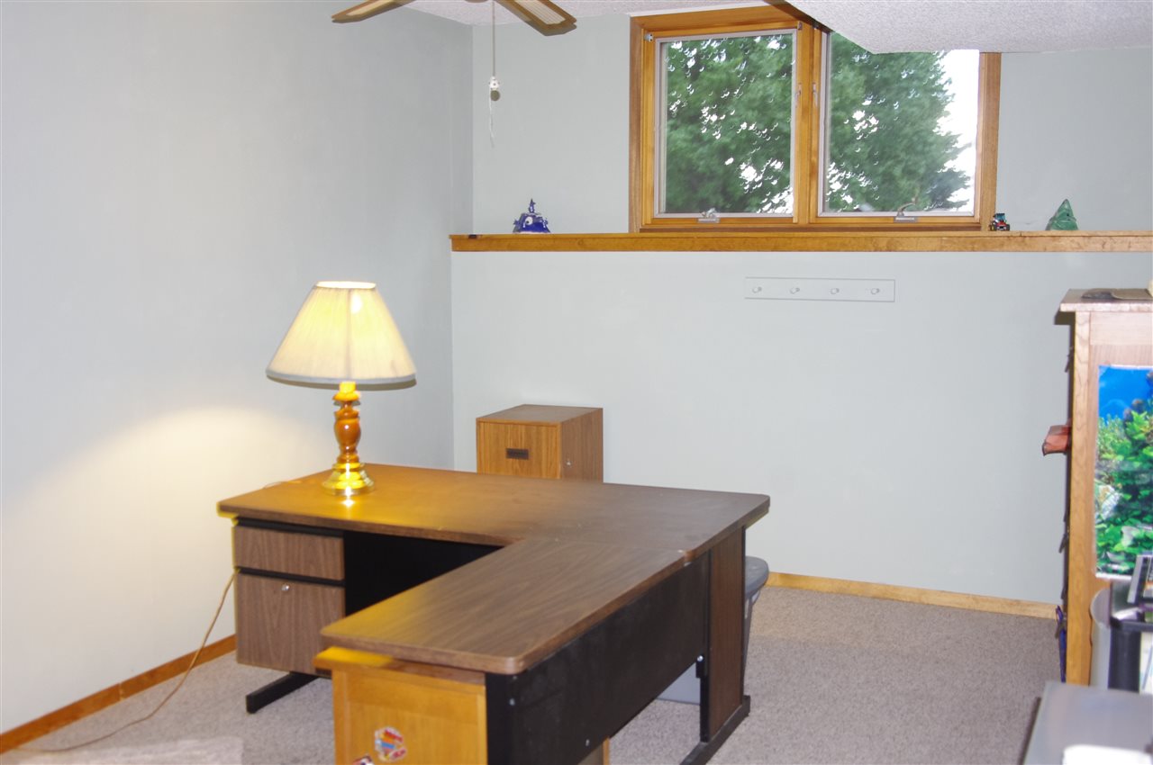 8407 North Kilbuck Road Monroe Center, IL 61052 - Photo 19 of 20 a living room with a table and a window