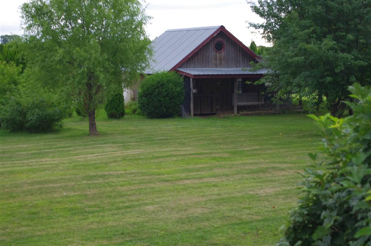 8407 North Kilbuck Road Monroe Center, IL 61052 - Photo 4 of 20 a front view of a house with a yard