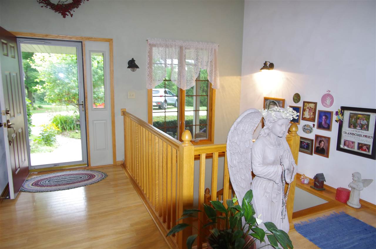8407 North Kilbuck Road Monroe Center, IL 61052 - Photo 5 of 20 a view of entryway and hall with wooden floor