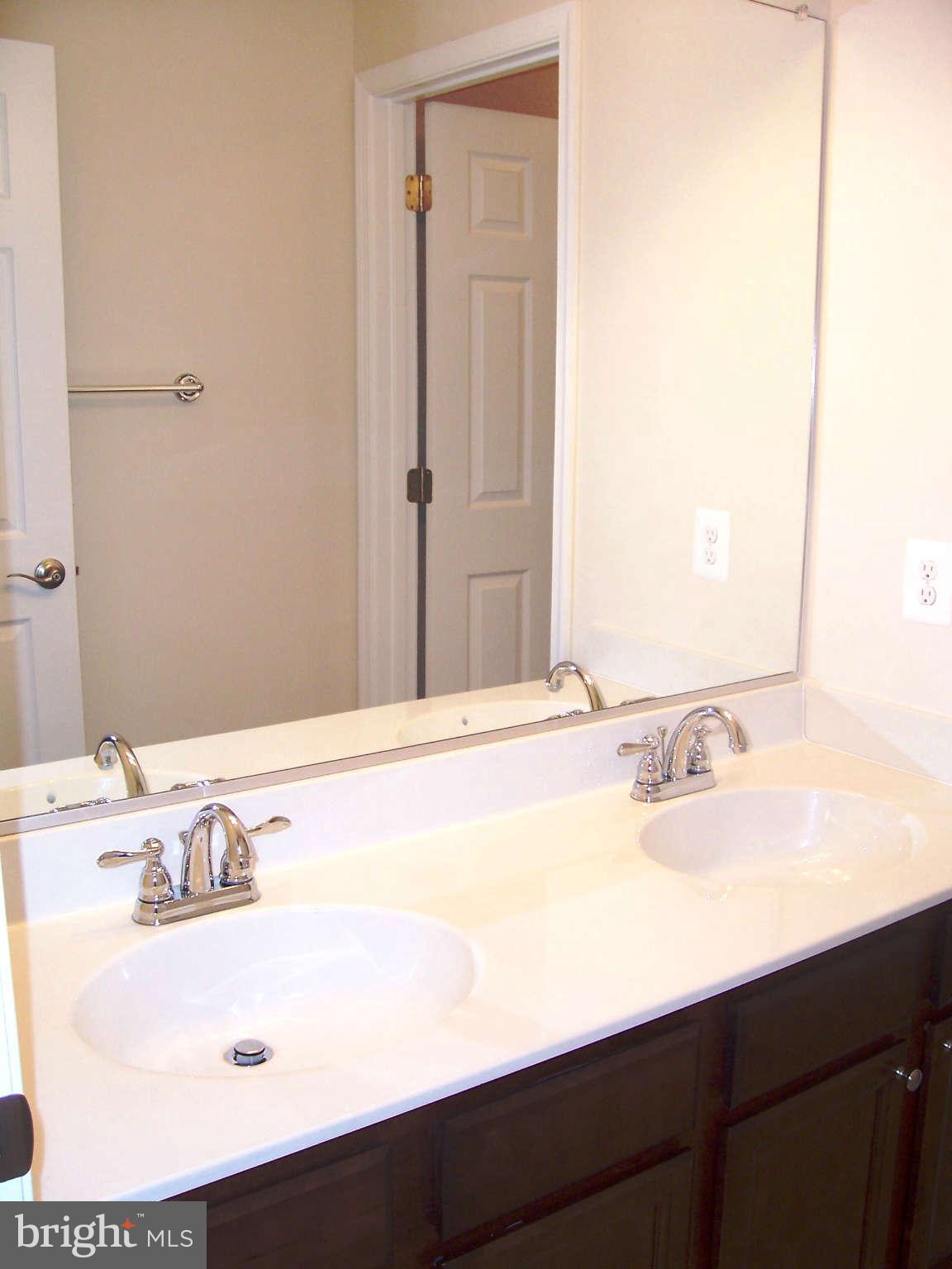 361 Emerson Road Owings, MD 20736 - Photo 17 of 25 a bathroom with a sink and a mirror