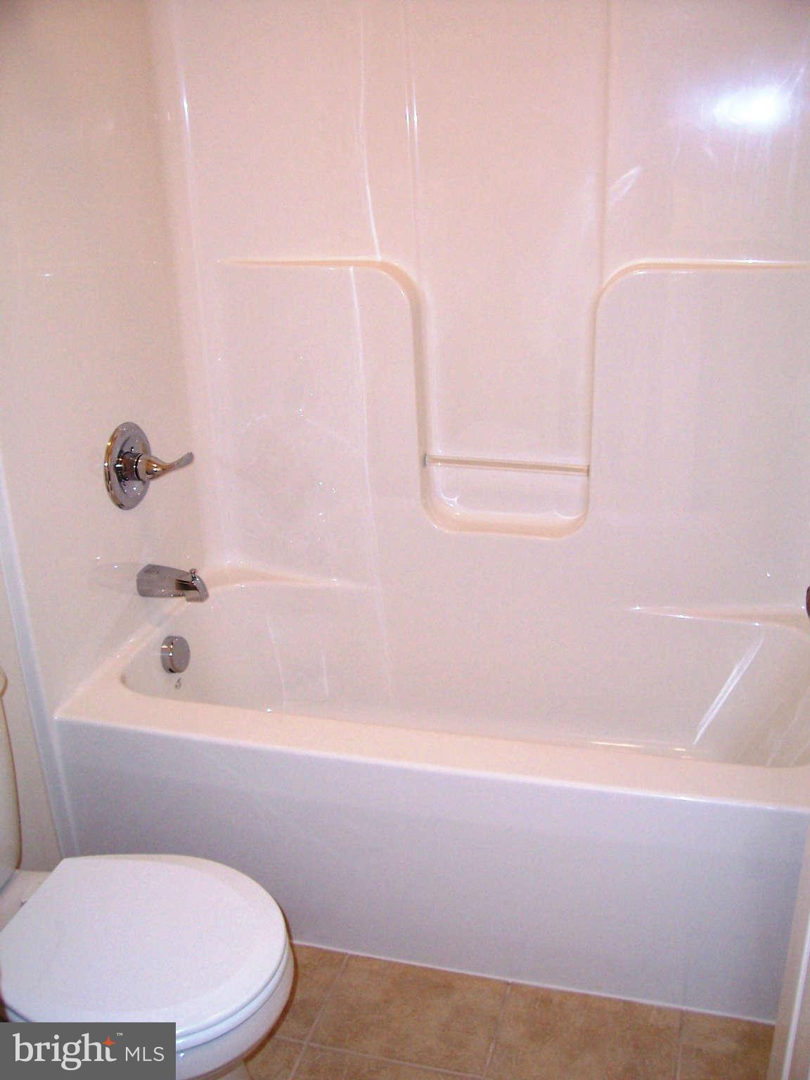361 Emerson Road Owings, MD 20736 - Photo 18 of 25 a bathroom with a bathtub and a toilet