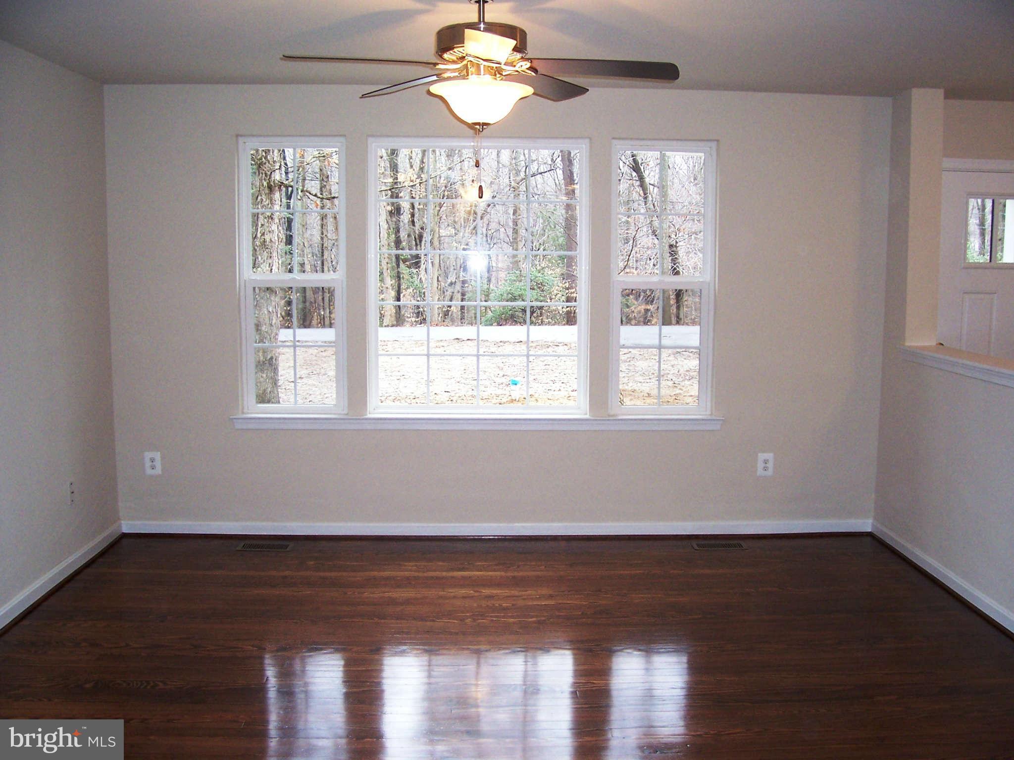 361 Emerson Road Owings, MD 20736 - Photo 3 of 25 a view of wooden floor and windows in a room