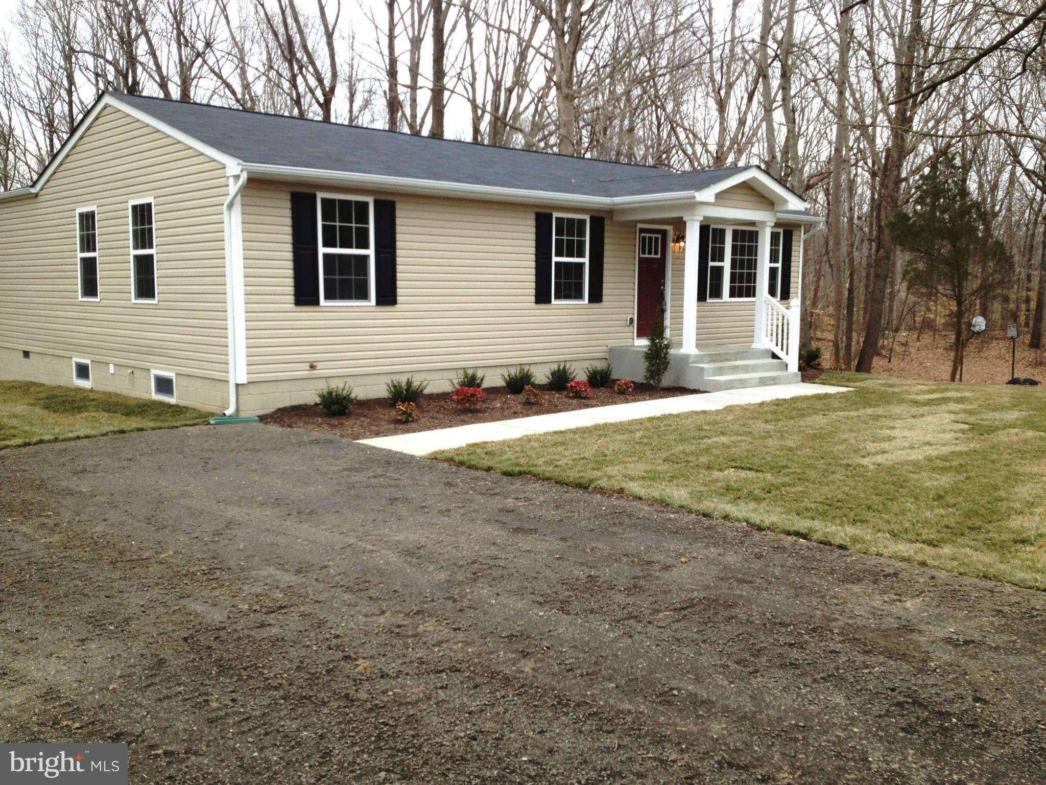 361 Emerson Road Owings, MD 20736 - Photo 22 of 25 a view of a house with a yard and trees