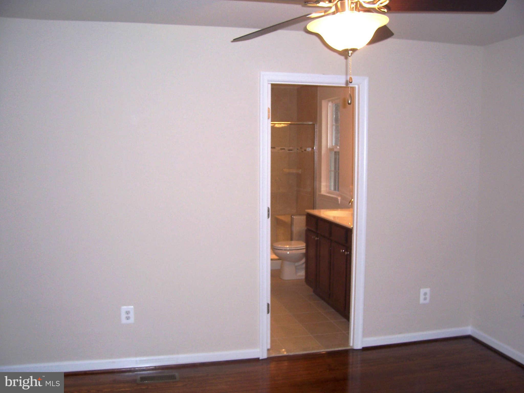 361 Emerson Road Owings, MD 20736 - Photo 10 of 25 a view of a hallway with wooden floor and a cabinet