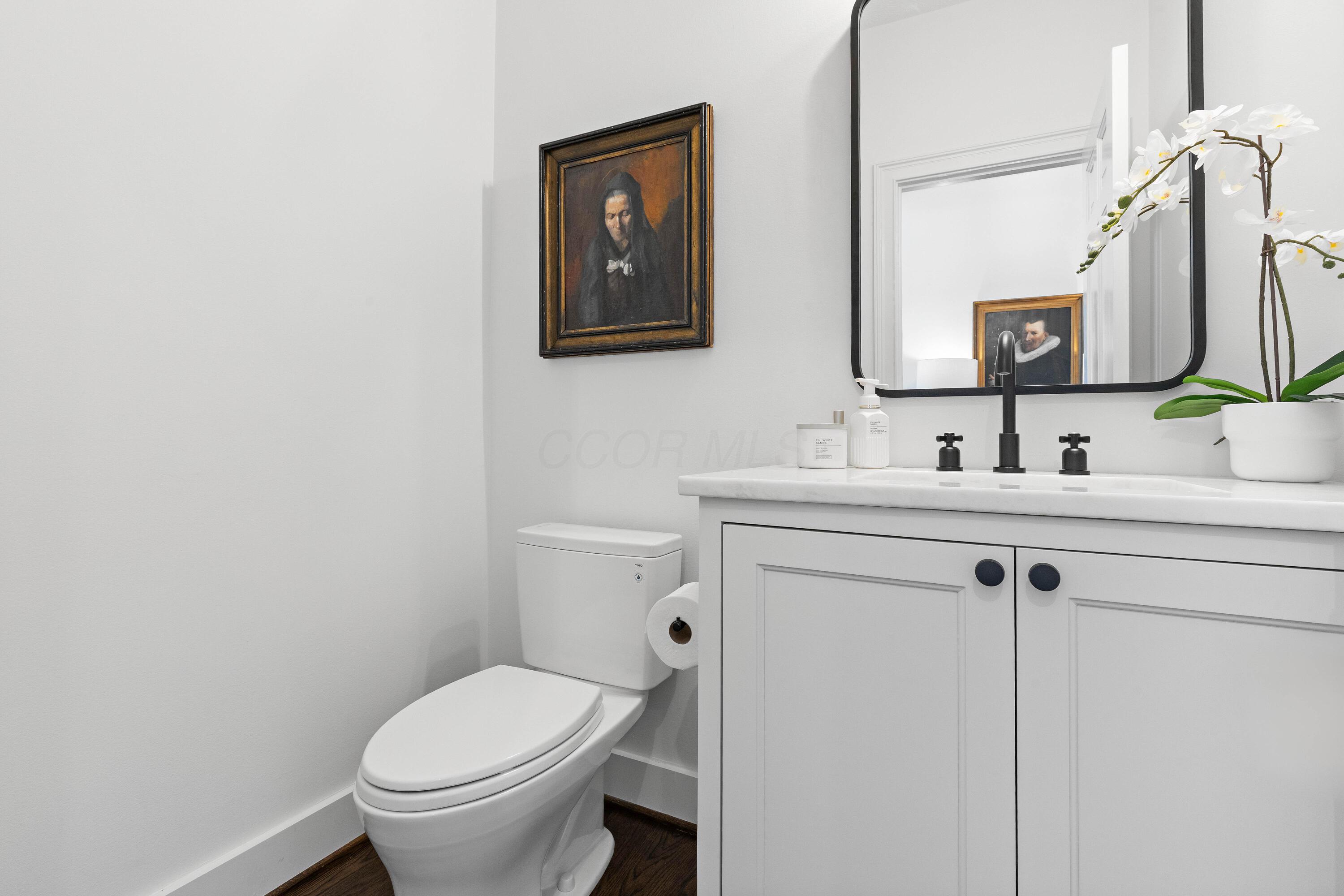 1364 Dale Ford Road Delaware, OH 43015 - Photo 19 of 112 • Hardwood flooring • White painted walls • Ceiling exhaust • Custom built enclosed vanity with single bowl, marble sinktop • 2 bulb wall light • Mirror remains