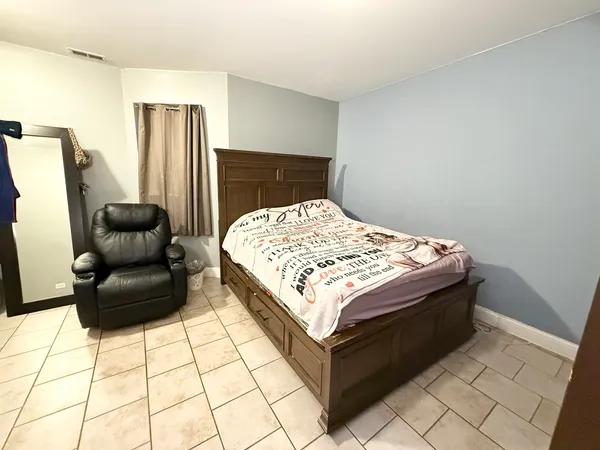 a bedroom with a bed and a mirror