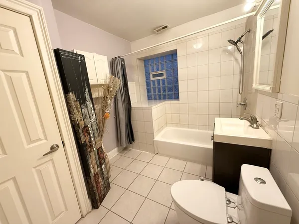 a bathroom with a toilet a sink and bathtub