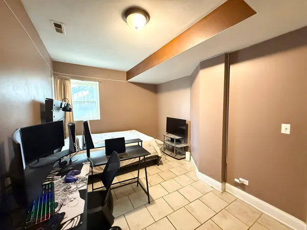 a bedroom with a bed and a desk