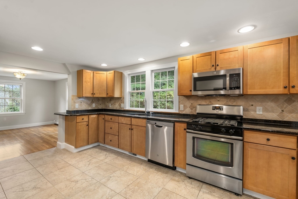 92 Abbot Street Andover, MA 01810 - Photo 10 of 35 a kitchen with stainless steel appliances granite countertop a stove top oven a sink and a microwave