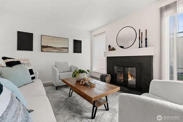 a living room with furniture a rug and a fireplace