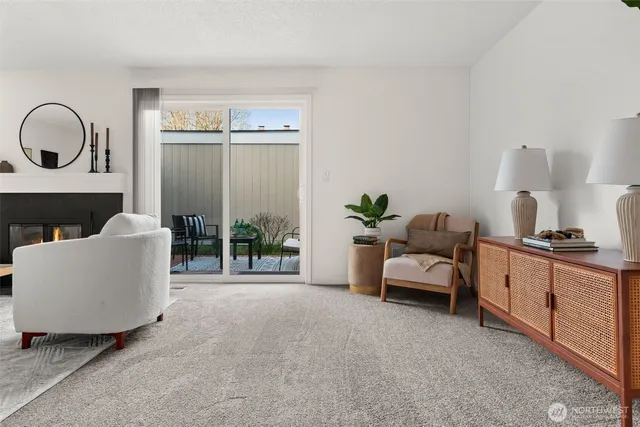 a living room with furniture a window and a potted plant