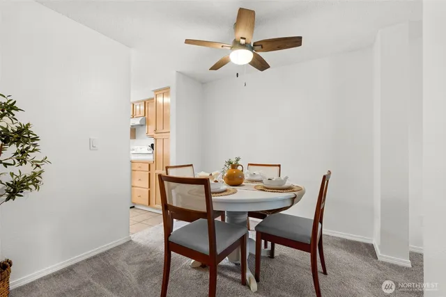 a view of a dining room with furniture and a potted plant