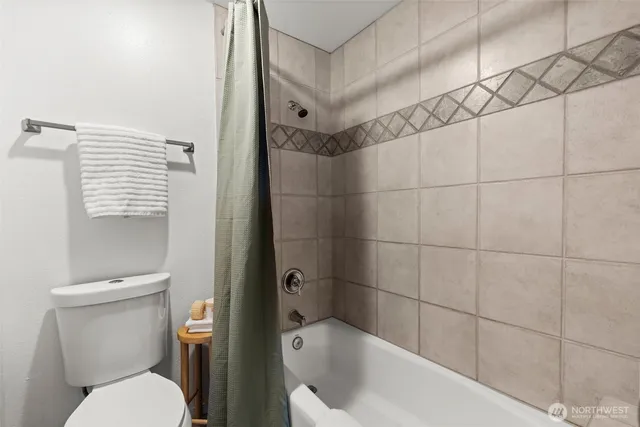 a bathroom with a toilet and shower