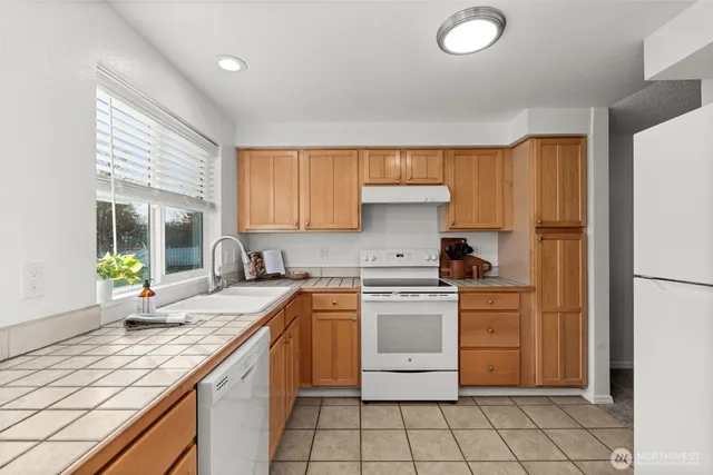a kitchen with a stove a sink and a refrigerator