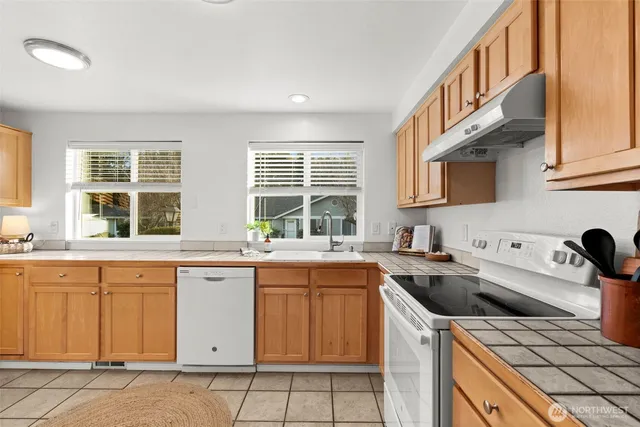 a kitchen that has a sink and a stove in it