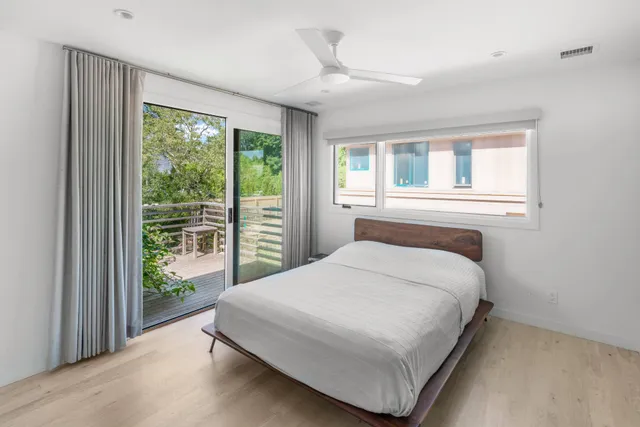a bedroom with a large bed and a large window
