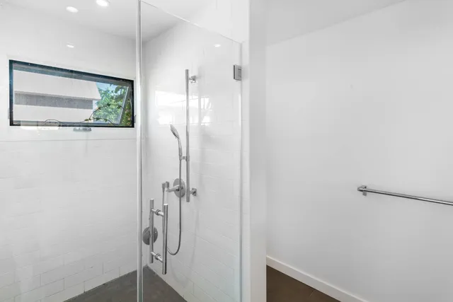 a bathroom with a shower and a sink