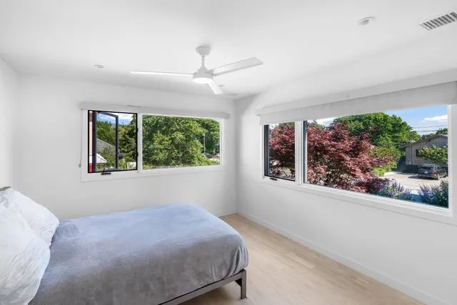 a bed room with a bed and a large window