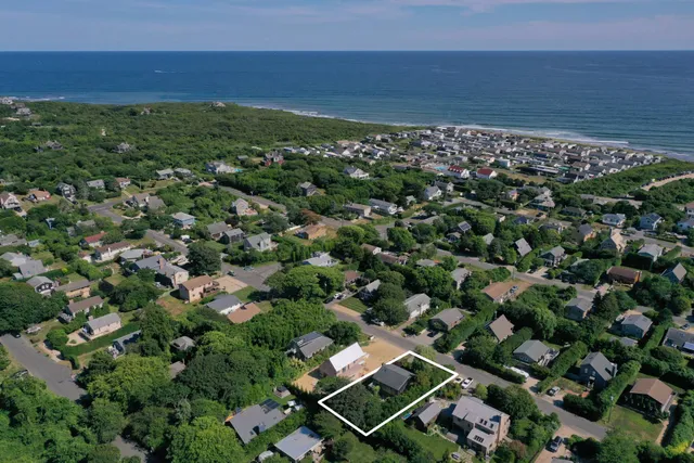 an aerial view of a houses with a yard