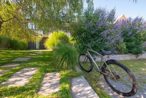 a backyard of a house with lots of green space and fountain
