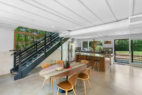 a dining room with furniture window and wooden floor