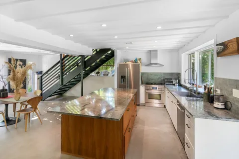 a kitchen with stainless steel appliances granite countertop a stove and cabinets