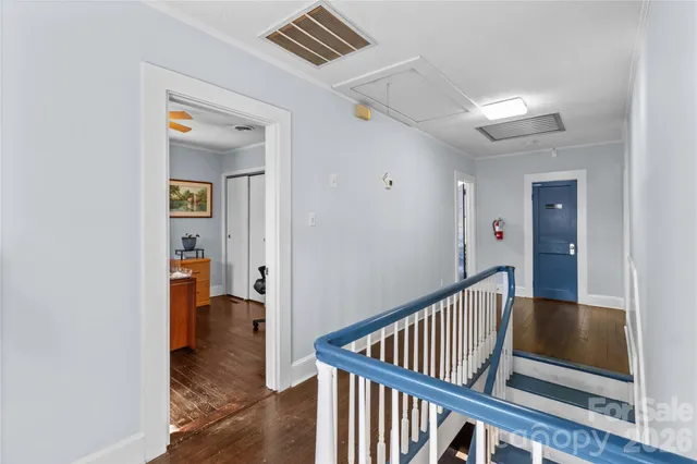 a view of a hallway with wooden floor and entryway