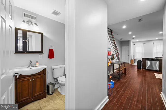 a bathroom with a sink vanity and toilet