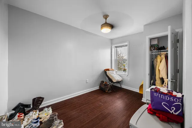 a view of a hallway with bathroom and wooden floor