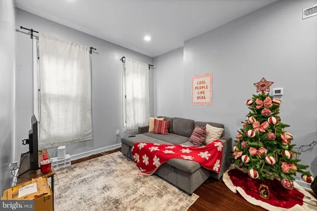 a kitchen view with wooden floor and stainless steel appliances