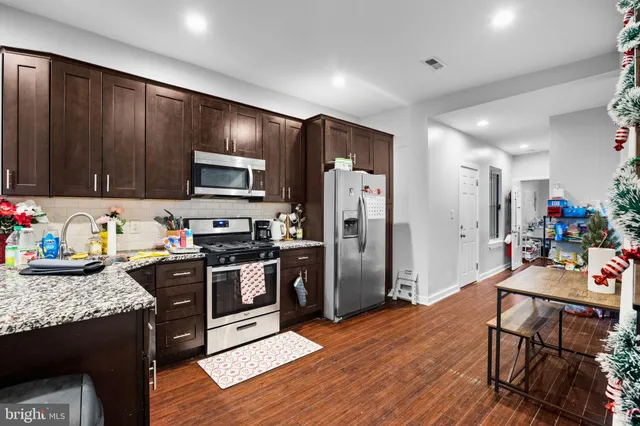 a kitchen with a refrigerator stove and microwave