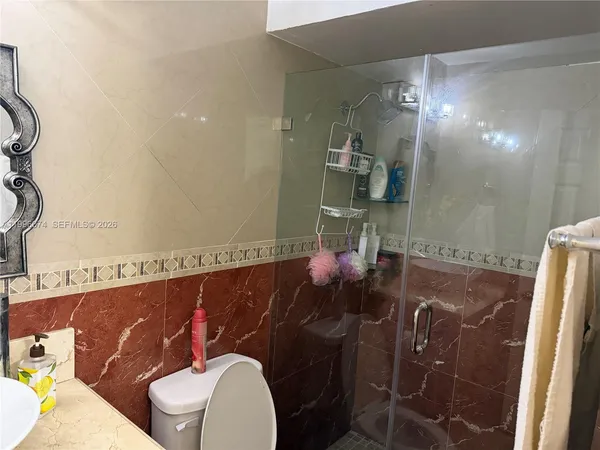 a bathroom with a toilet and shower