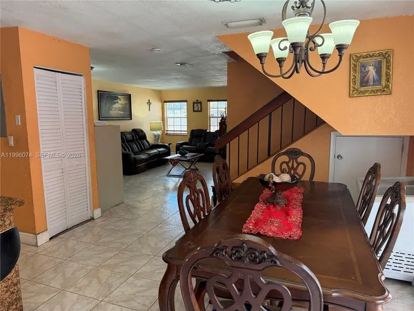 a view of a livingroom with furniture entryway and stairs