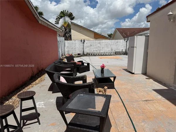 a view of a patio with couple of chairs