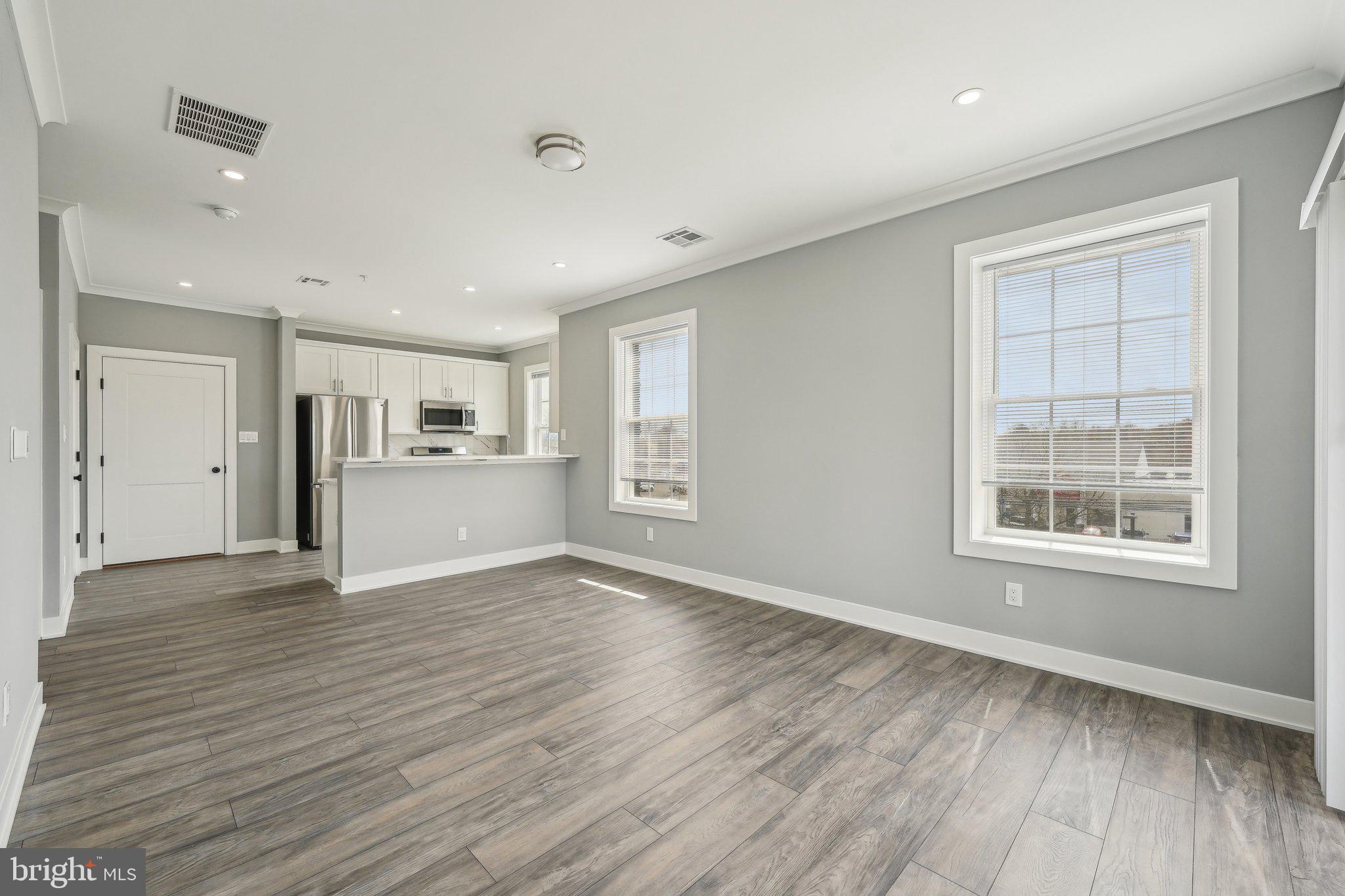 2421 Bristol Road, Unit 1B203 Warrington, PA 18976 - Photo 13 of 50 a view of an empty room with wooden floor and a window