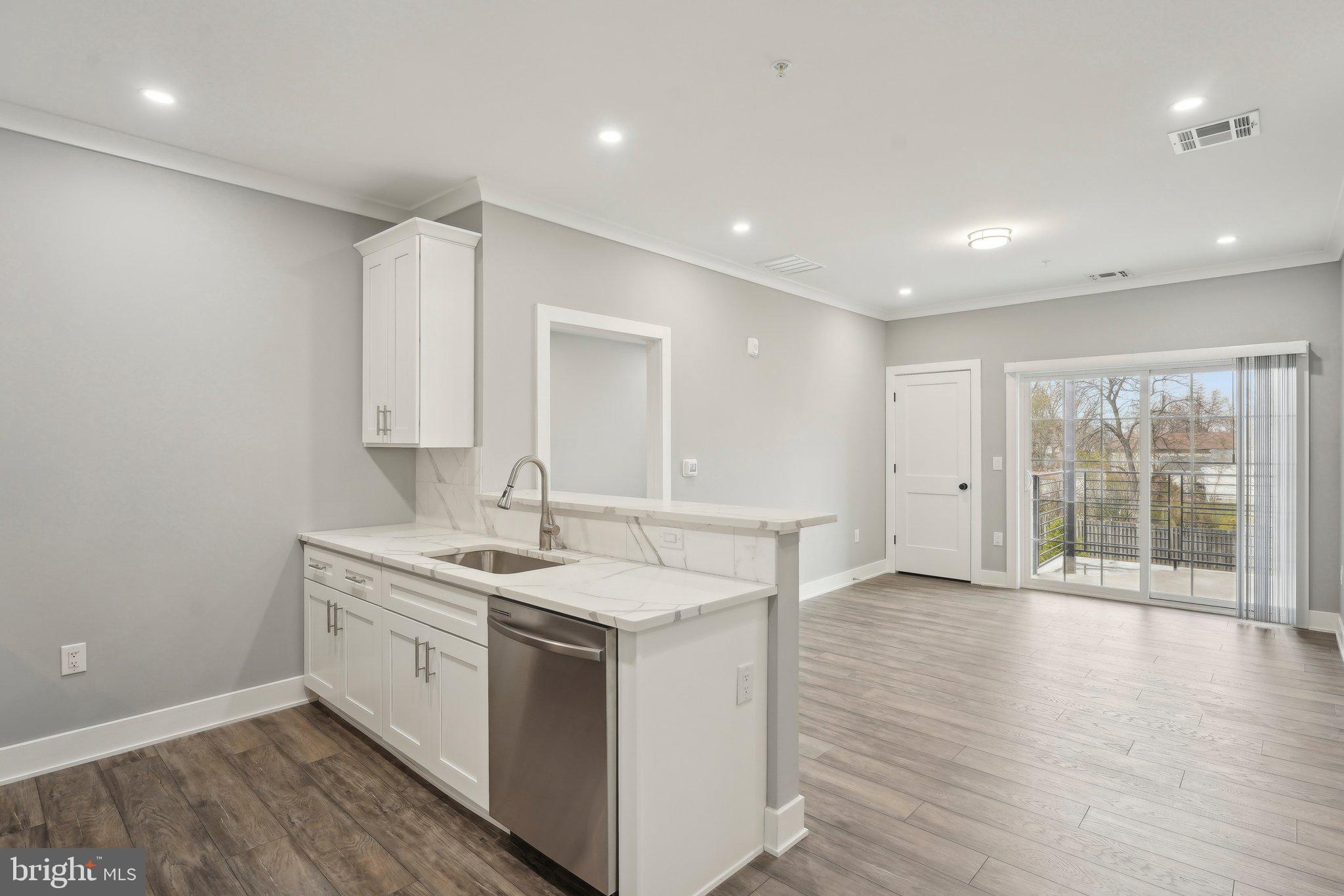 2421 Bristol Road, Unit 1B203 Warrington, PA 18976 - Photo 33 of 50 a view of a kitchen counter space with wooden floor