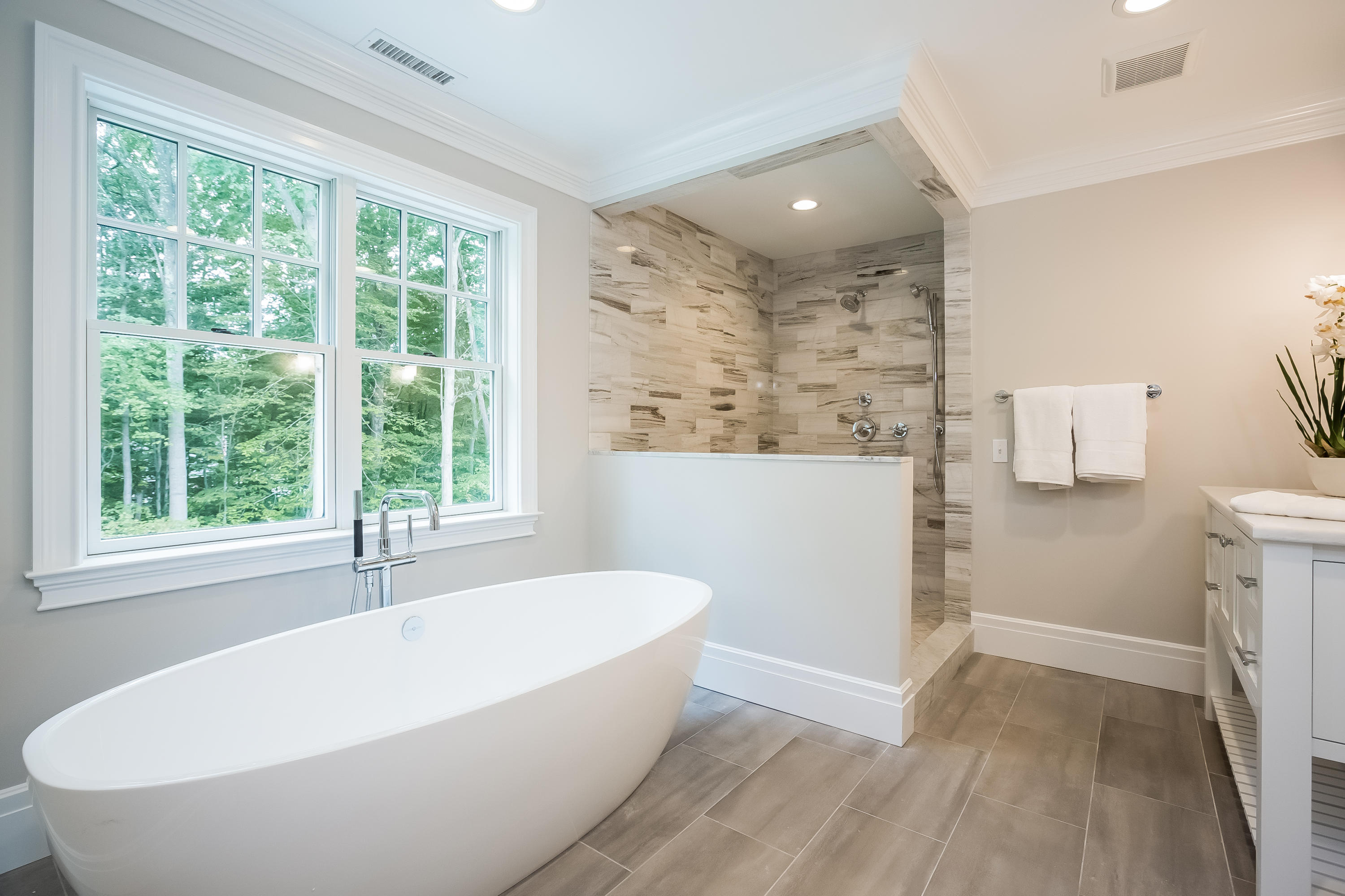 35 Old Parish Road Darien, CT 06820 - Photo 36 of 74 a white bath tub sitting in a bathroom next to a window