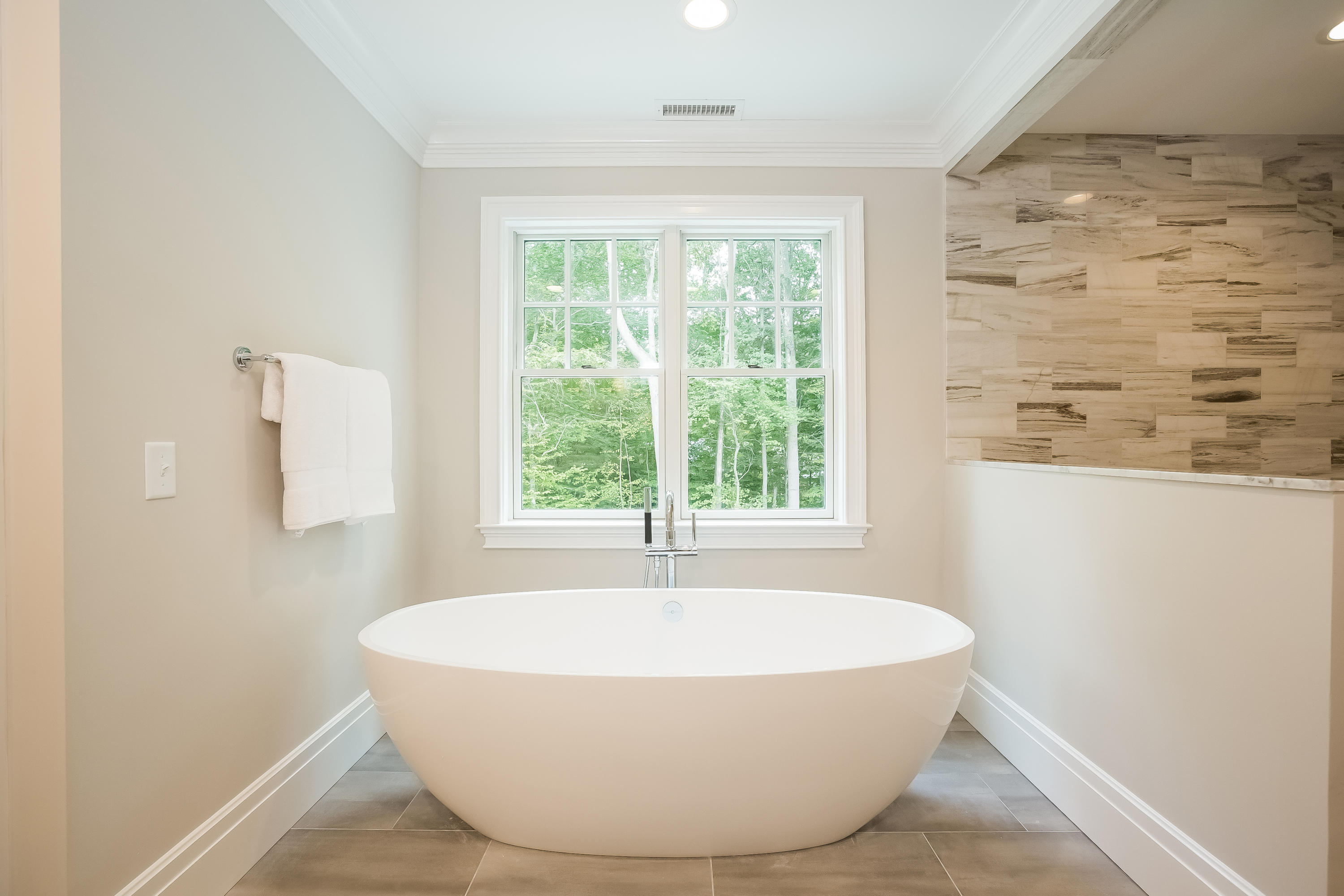 35 Old Parish Road Darien, CT 06820 - Photo 37 of 74 a white bath tub sitting in a bathroom next to a window