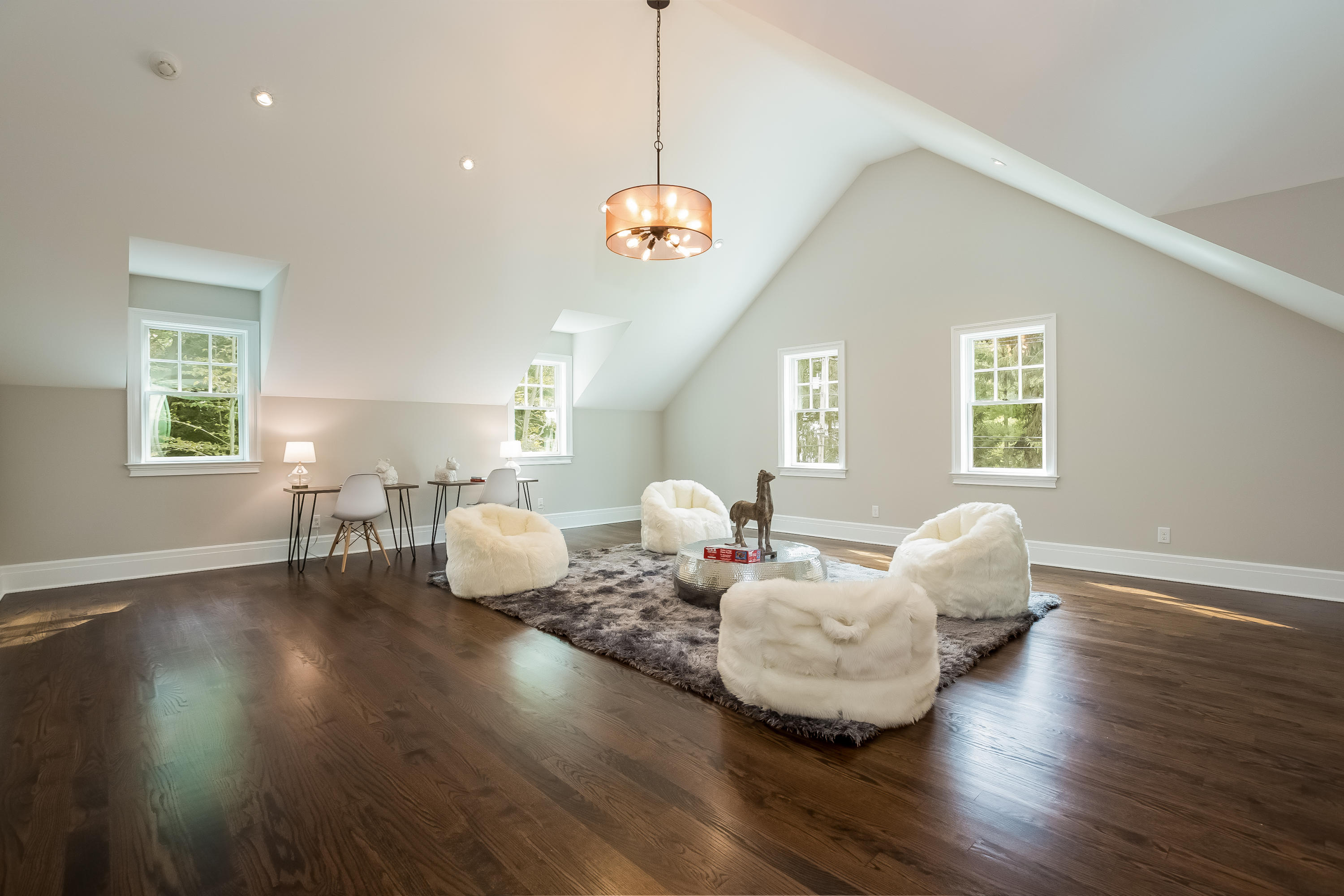 35 Old Parish Road Darien, CT 06820 - Photo 41 of 74 a living room with couches and a dining table with wooden floor