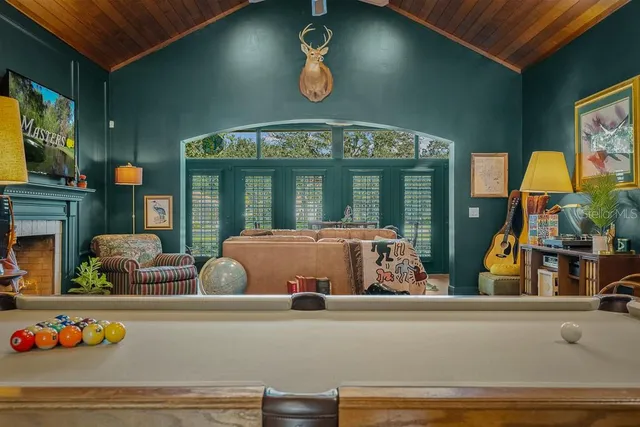 a living room with furniture and a floor to ceiling window