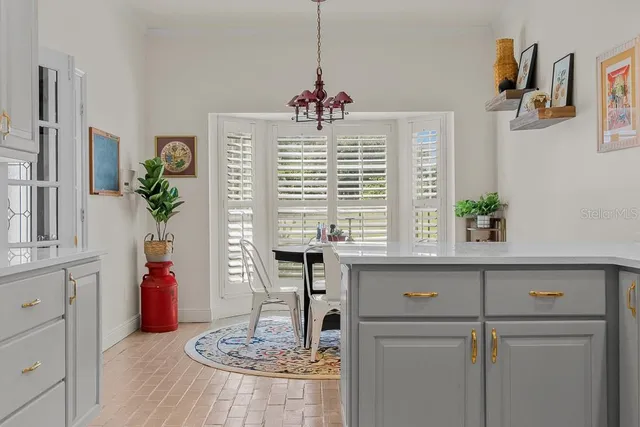 a living room with furniture and flower pot