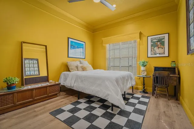 a bedroom with a bed and wooden floor