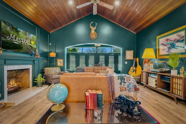 a living room with furniture a fireplace and a flat screen tv