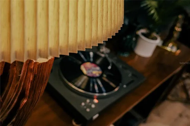 a vase of flowers sitting on a table with chairs