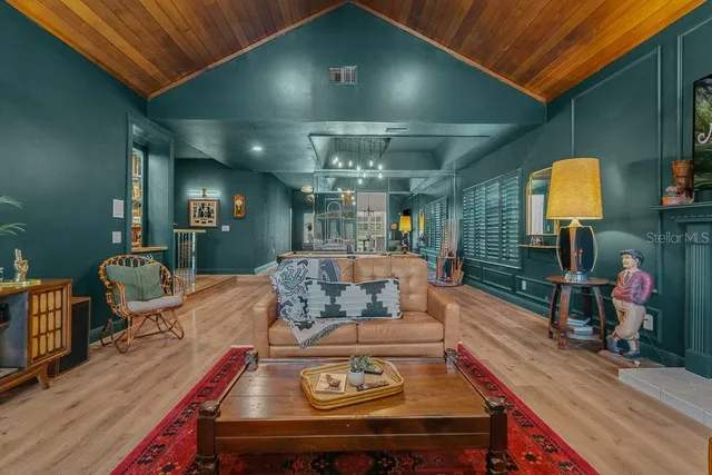 a living room with furniture and chandelier