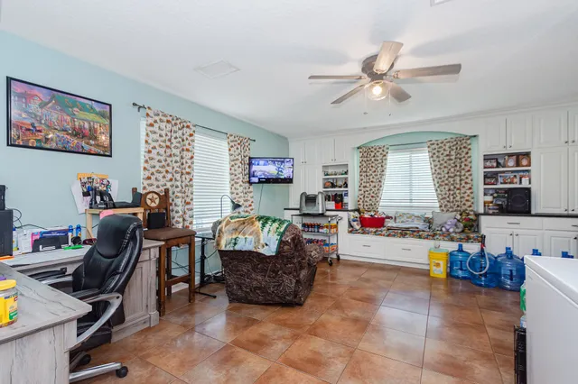 a living room filled with furniture and a window