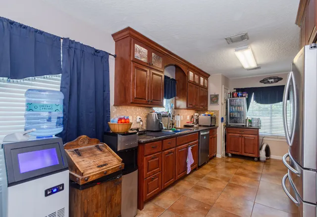 a kitchen with a stove top oven sink and cabinets