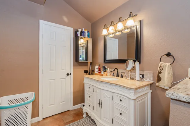 a bathroom with a sink a vanity and a mirror