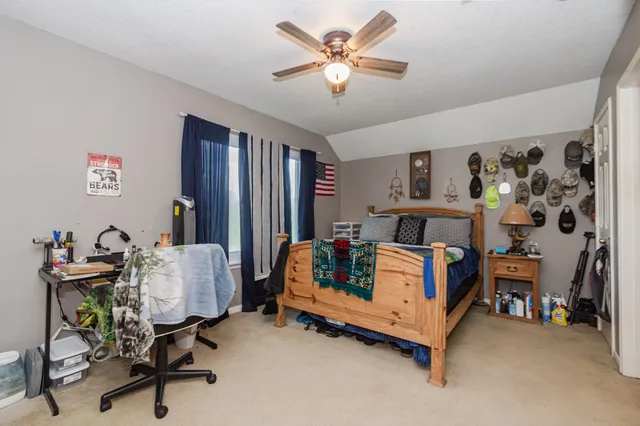 a bedroom with a bed and a chandelier