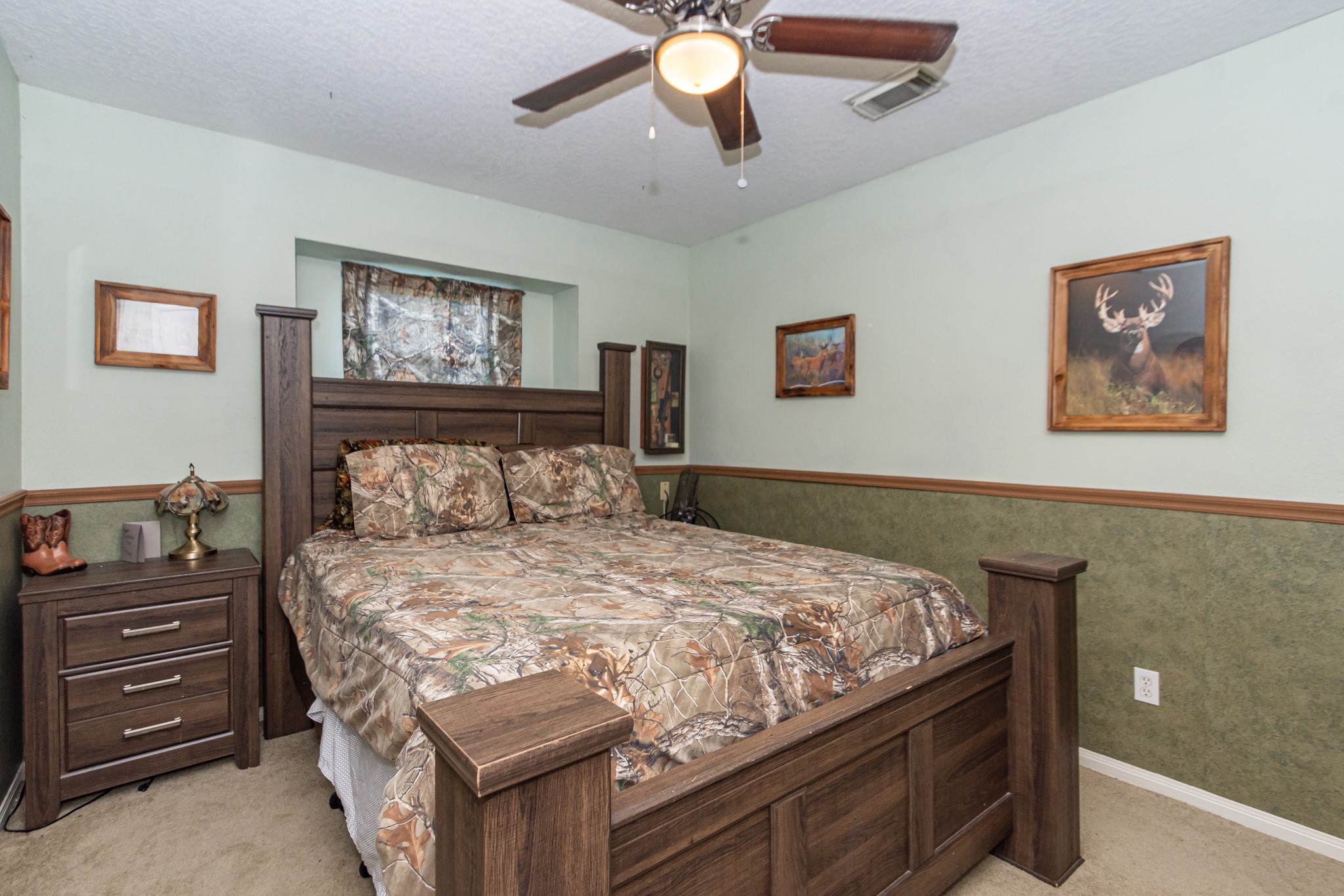 3625 County Road 36 Angleton, TX 77515 - Photo 30 of 50 a bedroom with a bed and a chandelier